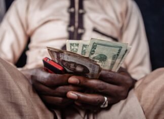 African Nations Struggle with Dollar Shortage as Investors Seek Secure Currencies A street currency dealer at a market in Lagos.Photographer: Benson Ibeabuchi/Bloomberg